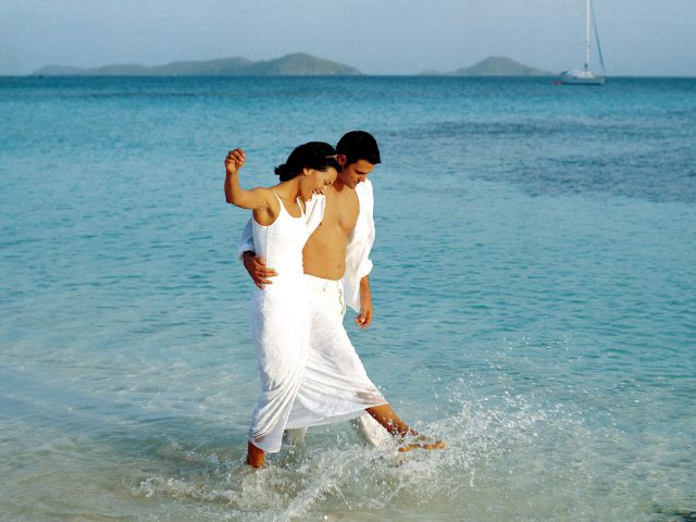 Couple Splashing In The Sea